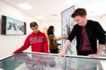 Two medical students stand over a table looking at it together